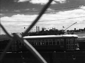 Black-and-white photograph of a tram framed by crossing lines